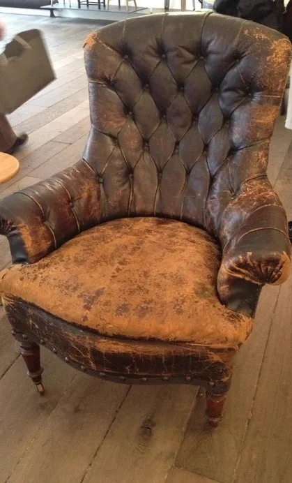 Faded, worn leather sofa before restoration